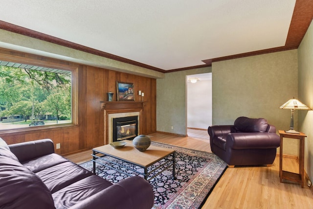 3748 Hilltop Rd, Minnetonka, MN 55305 - living area with light wood-type flooring, a glass covered fireplace, and ornamental molding
