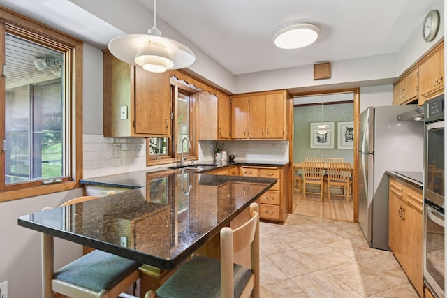 3748 Hilltop Rd, Minnetonka, MN 55305 - kitchen with healthy amount of natural light, backsplash, a peninsula, and a kitchen breakfast bar