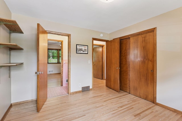 3748 Hilltop Rd, Minnetonka, MN 55305 - unfurnished bedroom featuring light wood-type flooring and a closet
