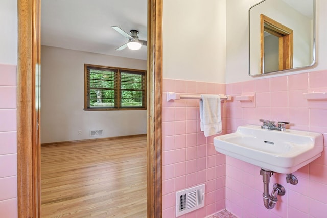 3748 Hilltop Rd, Minnetonka, MN 55305 - bathroom with ceiling fan, wood finished floors, and wainscoting
