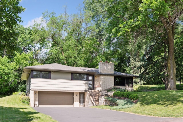 3748 Hilltop Rd, Minnetonka, MN 55305 - view of front of house featuring brick siding, a chimney, a garage, asphalt driveway, and a front lawn