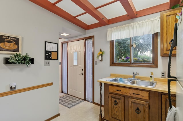 2921 Cambridge Ln, Mound, MN 55364 - kitchen with light floors, light countertops, brown cabinetry, and beam ceiling