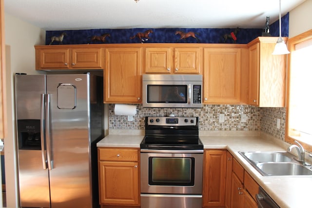 1508 6th Ave S, Sartell, MN 56377 - kitchen with appliances with stainless steel finishes, light countertops, and decorative backsplash