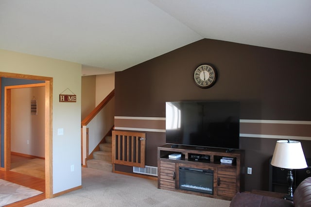 1508 6th Ave S, Sartell, MN 56377 - carpeted living area with stairway, lofted ceiling, and a glass covered fireplace