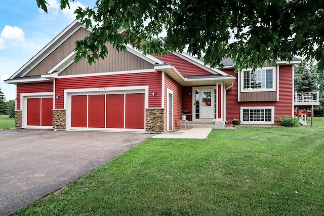 22493 Carina Ct, Farmington, MN 55024 - view of front of house with stone siding, a front yard, an attached garage, and asphalt driveway