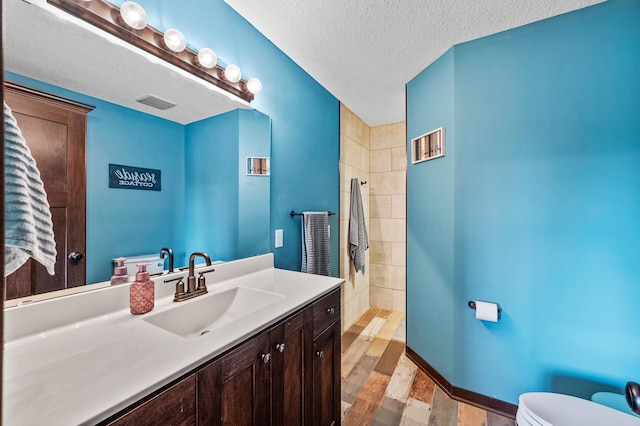 22493 Carina Ct, Farmington, MN 55024 - bathroom with vanity, walk in shower, wood finished floors, and a textured ceiling