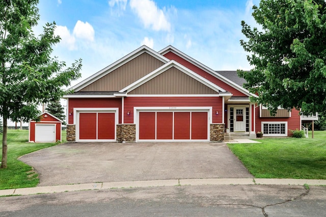 22493 Carina Ct, Farmington, MN 55024 - craftsman-style home with stone siding, asphalt driveway, a front yard, and a garage