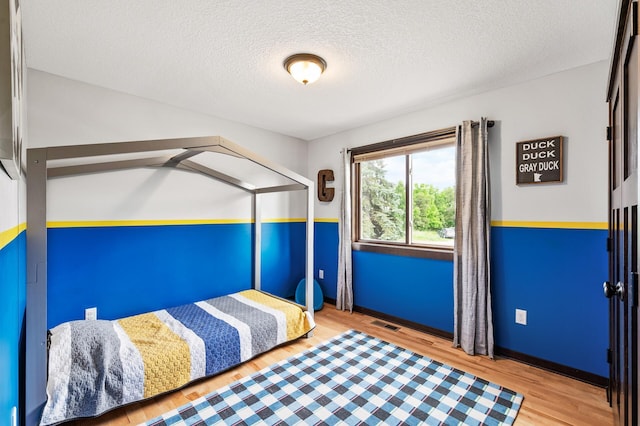 22493 Carina Ct, Farmington, MN 55024 - unfurnished bedroom with wood finished floors and a textured ceiling