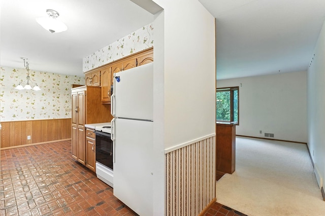 18612 Springcrest Dr, Minnetonka, MN 55345 - kitchen featuring white appliances, wallpapered walls, wainscoting, pendant lighting, and brown cabinets