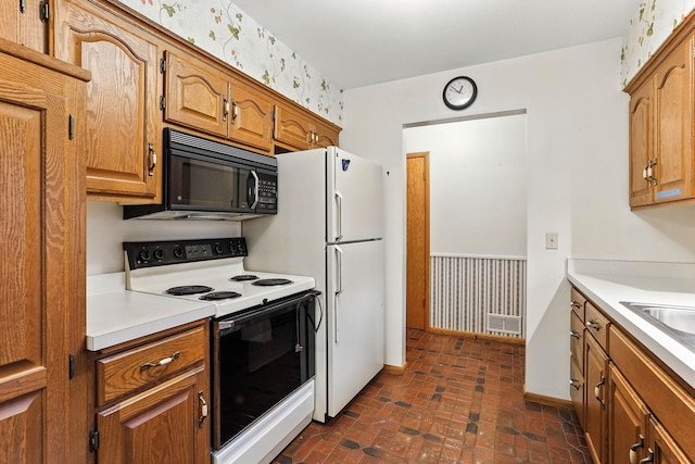 18612 Springcrest Dr, Minnetonka, MN 55345 - kitchen with white appliances, brown cabinetry, light countertops, and brick patterned flooring