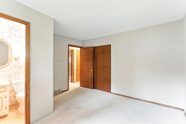 18612 Springcrest Dr, Minnetonka, MN 55345 - unfurnished bedroom featuring a closet, light carpet, and connected bathroom