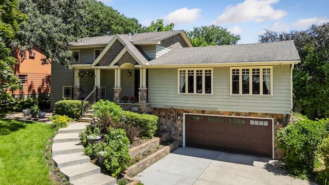 4011 Grimes Ave S, Edina, MN 55416 - craftsman-style home featuring concrete driveway, an attached garage, stone siding, and a shingled roof