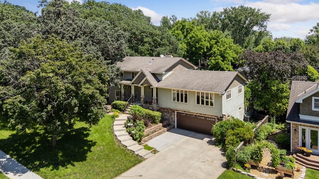 4011 Grimes Ave S, Edina, MN 55416 - craftsman-style house with stone siding, an attached garage, concrete driveway, and a front yard
