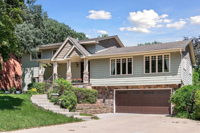 4011 Grimes Ave S, Edina, MN 55416 - craftsman-style house with stone siding, driveway, an attached garage, and a porch