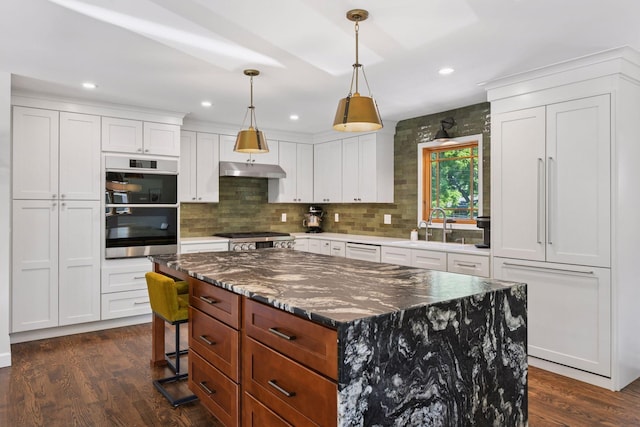 4011 Grimes Ave S, Edina, MN 55416 - kitchen with white cabinets, tasteful backsplash, dark wood-type flooring, a kitchen island, and recessed lighting