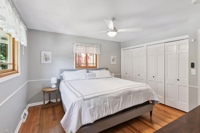 4011 Grimes Ave S, Edina, MN 55416 - bedroom featuring multiple closets, wood finished floors, and ceiling fan