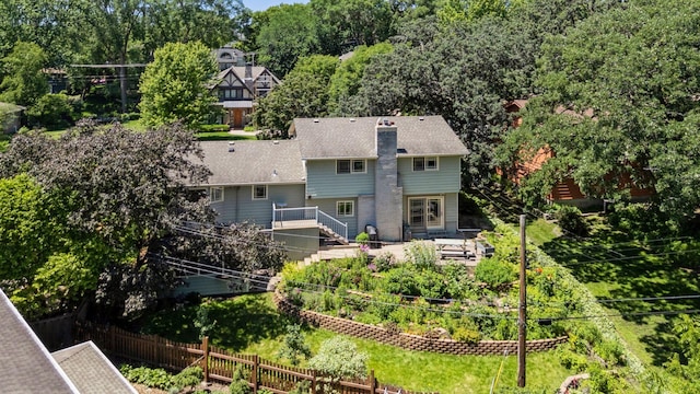 4011 Grimes Ave S, Edina, MN 55416 - back of house with a vegetable garden, stairway, and view of scattered trees