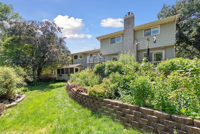 4011 Grimes Ave S, Edina, MN 55416 - rear view of property featuring a sunroom, a lawn, and a chimney