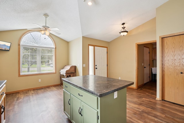 343 Tuttle Dr, Hastings, MN 55033 - kitchen with green cabinets, vaulted ceiling, ceiling fan, dark wood-style flooring, and dark countertops