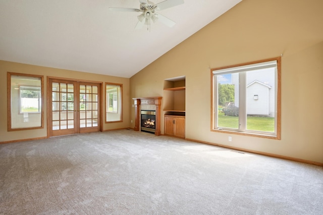 343 Tuttle Dr, Hastings, MN 55033 - unfurnished living room featuring high vaulted ceiling, healthy amount of natural light, light carpet, and a glass covered fireplace