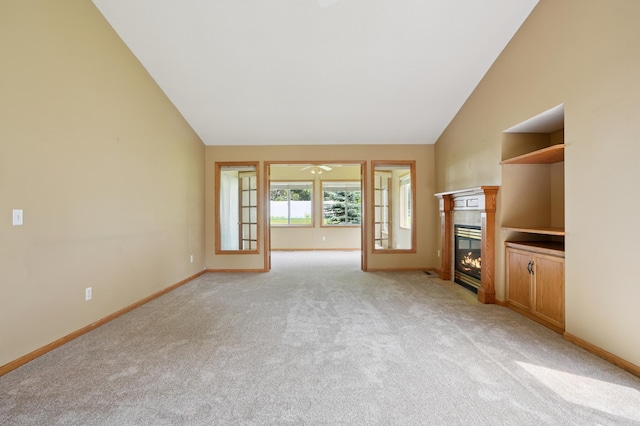 343 Tuttle Dr, Hastings, MN 55033 - unfurnished living room with a tiled fireplace, light carpet, and high vaulted ceiling