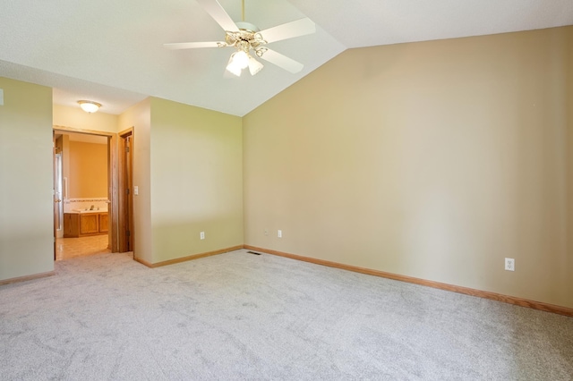 343 Tuttle Dr, Hastings, MN 55033 - unfurnished bedroom featuring light carpet, lofted ceiling, ensuite bath, and ceiling fan