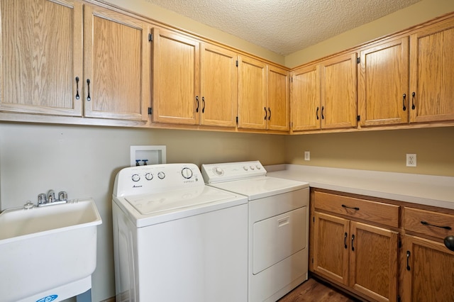 343 Tuttle Dr, Hastings, MN 55033 - laundry area with cabinet space, washing machine and dryer, a textured ceiling, and dark wood finished floors