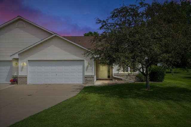 343 Tuttle Dr, Hastings, MN 55033 - view of front of house featuring a garage, concrete driveway, a lawn, and brick siding