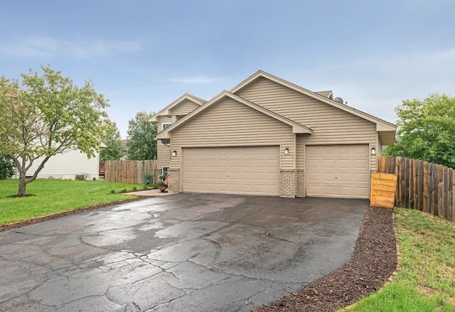 14617 Zilla St NW, Andover, MN 55304 - view of front of property with asphalt driveway, a garage, and brick siding