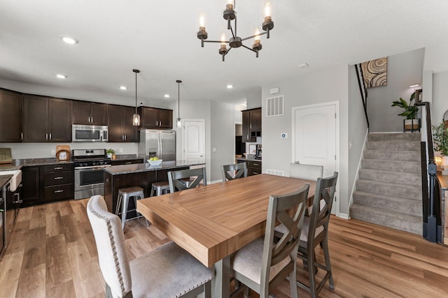 1174 139th St E, Rosemount, MN 55068 - dining area with light wood-type flooring, recessed lighting, a chandelier, and stairs