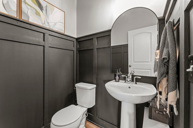 1174 139th St E, Rosemount, MN 55068 - half bathroom with a decorative wall, wainscoting, and wood finished floors