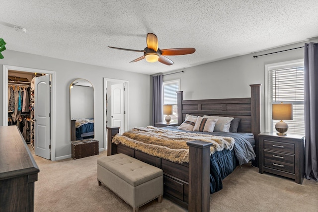1174 139th St E, Rosemount, MN 55068 - bedroom featuring light colored carpet, a walk in closet, ceiling fan, and a textured ceiling