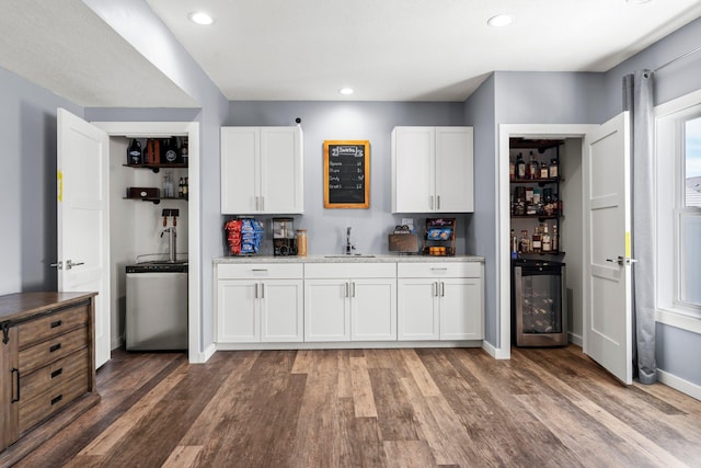 1174 139th St E, Rosemount, MN 55068 - kitchen with wine cooler, light wood-style floors, white cabinets, light stone counters, and recessed lighting