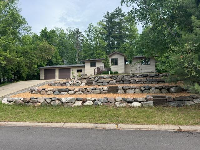 240 12th Ave, Grand Rapids, MN 55744 - view of front of home featuring concrete driveway and a garage