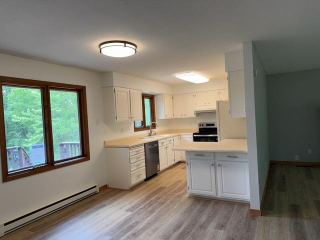 240 12th Ave, Grand Rapids, MN 55744 - kitchen featuring stainless steel electric stove, baseboard heating, dishwashing machine, and healthy amount of natural light