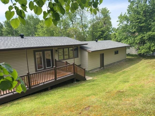 240 12th Ave, Grand Rapids, MN 55744 - rear view of house with a shingled roof, a deck, and a yard