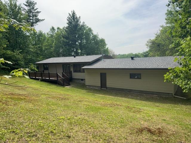 240 12th Ave, Grand Rapids, MN 55744 - back of house with a lawn and a deck