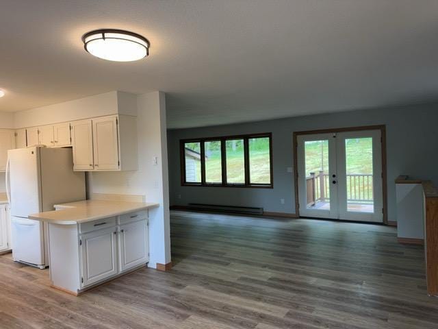 240 12th Ave, Grand Rapids, MN 55744 - kitchen with baseboard heating, healthy amount of natural light, and white cabinetry