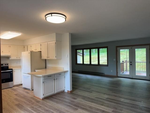 240 12th Ave, Grand Rapids, MN 55744 - kitchen with electric stove, baseboard heating, freestanding refrigerator, ventilation hood, and light countertops