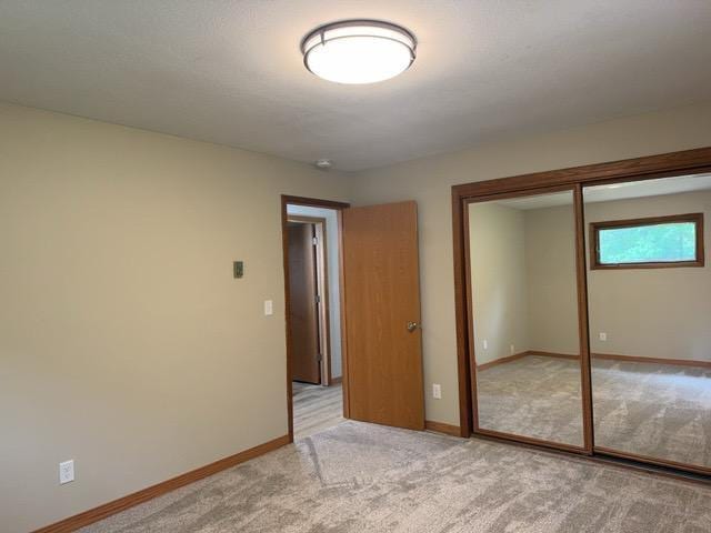 240 12th Ave, Grand Rapids, MN 55744 - unfurnished bedroom featuring a closet and light carpet