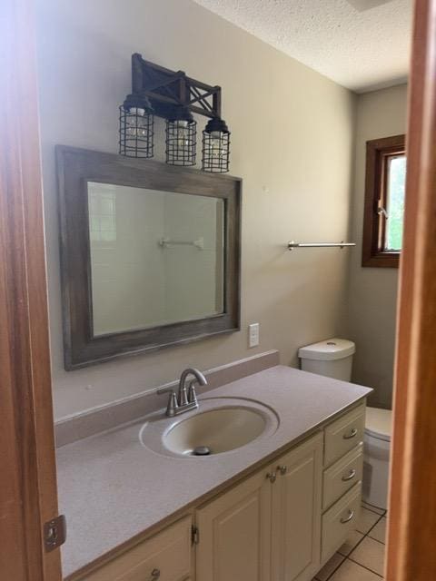 240 12th Ave, Grand Rapids, MN 55744 - bathroom featuring a textured ceiling, vanity, and tile patterned flooring