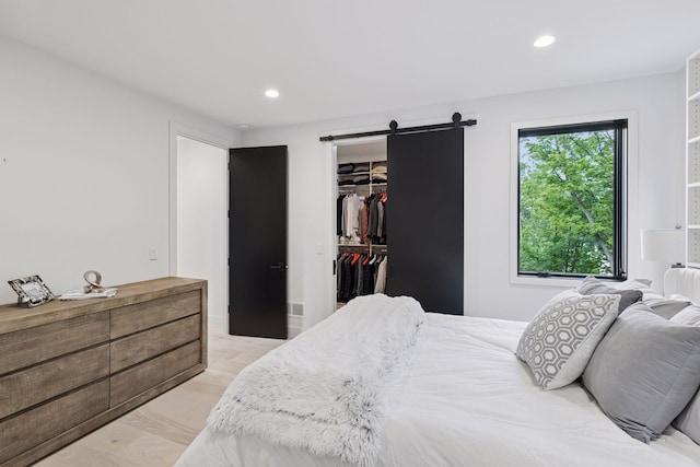 1300 Wildhurst Trl, Orono, MN 55364 - bedroom featuring recessed lighting, a barn door, a spacious closet, and a closet