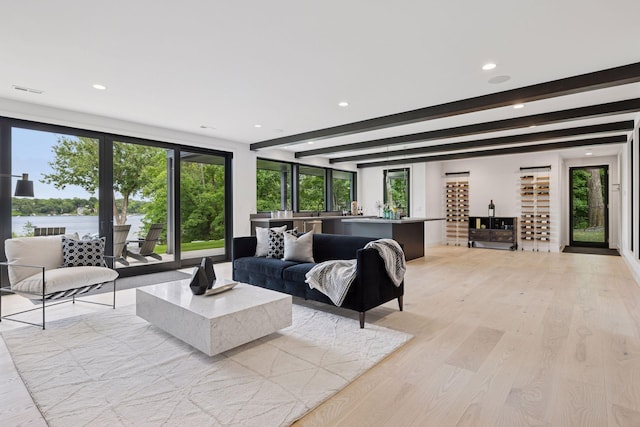 1300 Wildhurst Trl, Orono, MN 55364 - living room with recessed lighting, beam ceiling, light wood finished floors, and a water view