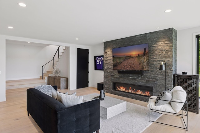 1300 Wildhurst Trl, Orono, MN 55364 - living room featuring a fireplace, stairway, wood finished floors, and recessed lighting