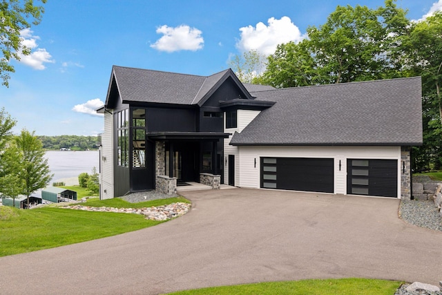 1300 Wildhurst Trl, Orono, MN 55364 - view of front of property with stone siding, a garage, a shingled roof, and asphalt driveway