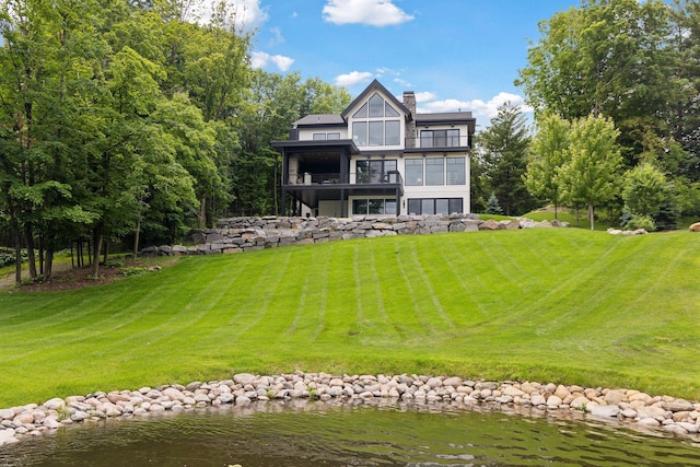 1300 Wildhurst Trl, Orono, MN 55364 - back of property with a lawn, a chimney, a balcony, and a water view