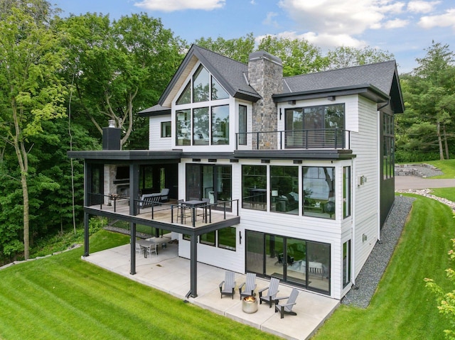 1300 Wildhurst Trl, Orono, MN 55364 - back of property featuring a chimney, a balcony, a patio area, and a lawn