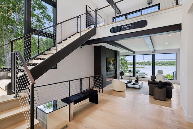 1300 Wildhurst Trl, Orono, MN 55364 - common area with a towering ceiling, stairs, beam ceiling, and a water view
