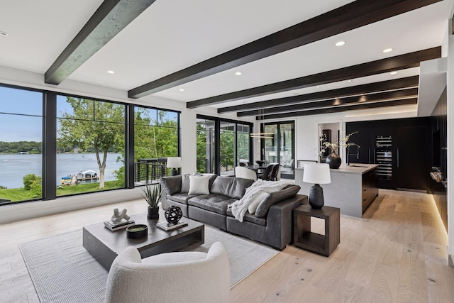 1300 Wildhurst Trl, Orono, MN 55364 - living area with beamed ceiling, light wood-style flooring, recessed lighting, and a water view