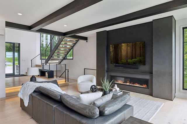 1300 Wildhurst Trl, Orono, MN 55364 - living area featuring beam ceiling, stairway, light wood finished floors, a glass covered fireplace, and recessed lighting